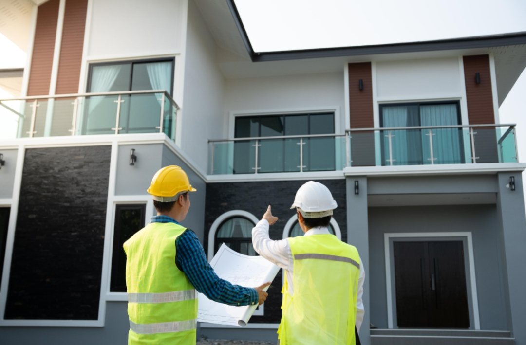 Crimson Trading team reviewing building plans on site