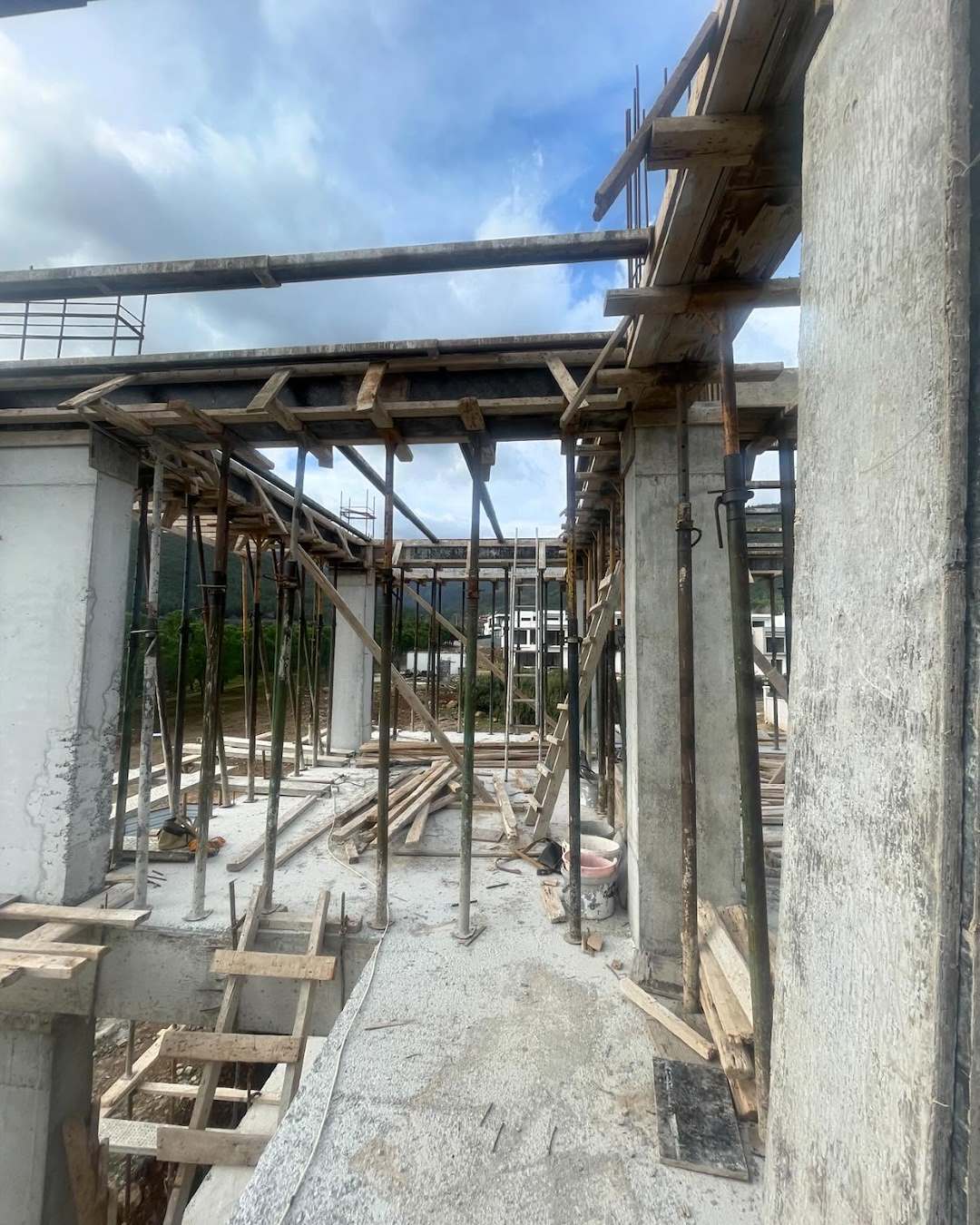 Walkway area with props and timber formwork on a construction site